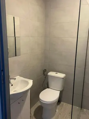 a bathroom with a toilet and a sink at Noclegi Eliza in Dąbrowa Górnicza