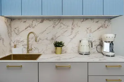 a kitchen counter with a sink and a coffee maker at Apartment Blue near Schindler in Kraków