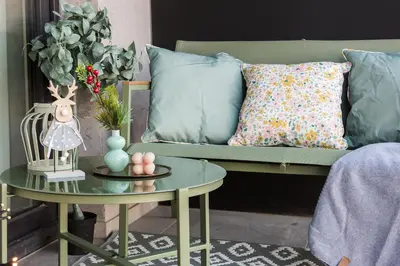 a living room with a couch with pillows and a table at Apartment Blue near Schindler in Kraków