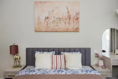 a bedroom with a bed with a painting on the wall at Apartment Blue near Schindler in Kraków