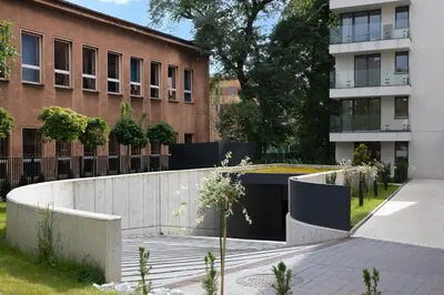 a courtyard in a building with a concrete wall at Metropolis Design Apartments in Kraków