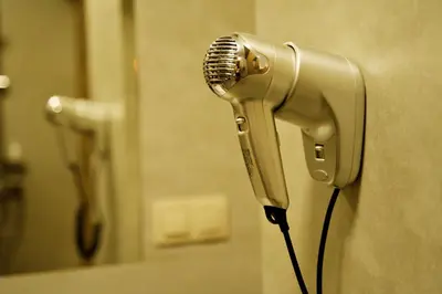a hair dryer in a bathroom with a mirror at Apartamenty Galicja Zator in Zator