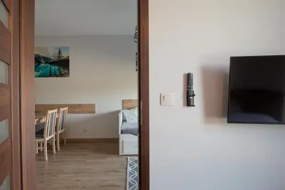 a door leading into a room with a dining room at Apartamenty Galicja Zator in Zator