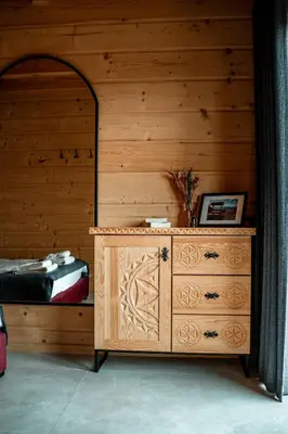 a wooden bedroom with a dresser and a bed at Makowy Zakątek in Maków Podhalański