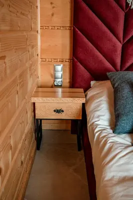 a bed and a nightstand in a room with a bed at Makowy Zakątek in Maków Podhalański