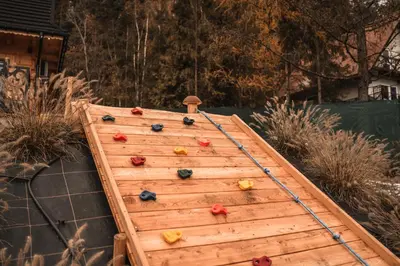 a wooden climbing wall with climbing balls on it at Makowy Zakątek in Maków Podhalański
