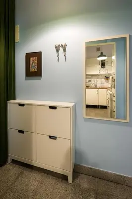 a room with a dresser and a mirror on a wall at Charming and stylish apartment in Kraków