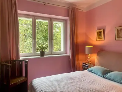 a bedroom with a bed and a window at Charming and stylish apartment in Kraków