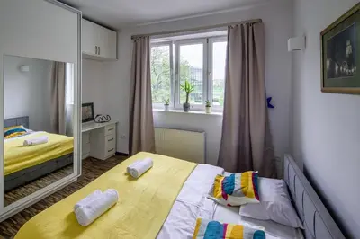 a bedroom with two beds and a large mirror at Comfort Apartment in great location in Kraków