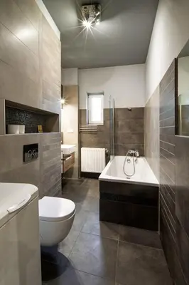 a bathroom with a tub and a toilet and a sink at Comfort Apartment in great location in Kraków