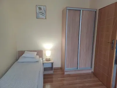 a bedroom with a bed and a sliding glass door at Apartament Natalia in Wadowice