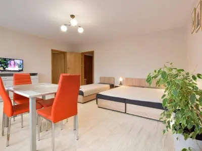a bedroom with a bed and a table and chairs at Apartament Natalia in Wadowice