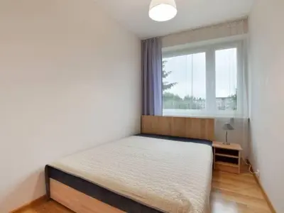 a bedroom with a bed and a window at Apartament Natalia in Wadowice