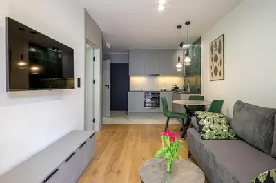 a living room with a couch and a table at High standard in top location in Kraków