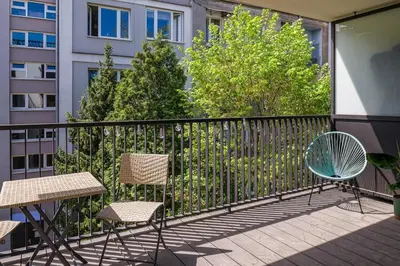 a balcony with two chairs and a table at High standard in top location in Kraków