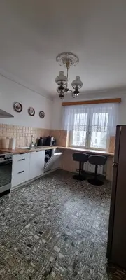 a kitchen with a table and two chairs in it at Górnica apart in Andrychów