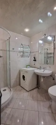 a bathroom with a sink and a washing machine at Górnica apart in Andrychów