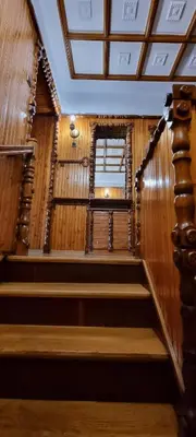 a staircase in a building with wooden walls and a window at Górnica apart in Andrychów