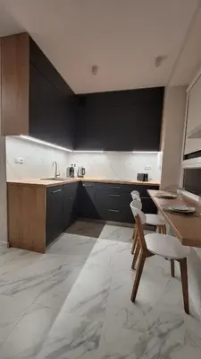 a kitchen with a sink and a table and a chair at Nowa Huta 12 in Kraków