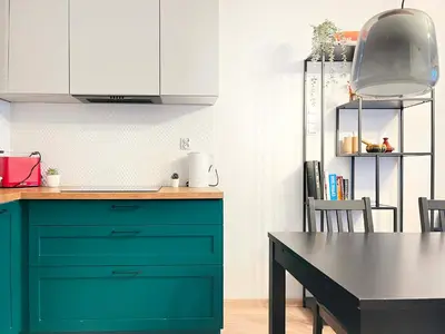 a kitchen with a green cabinet and a table at Apartment with Terrace and Two Bedrooms, Cracow Vistula Boulevards in Kraków