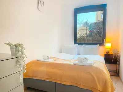 a bedroom with a bed with two towels on it at Apartment with Terrace and Two Bedrooms, Cracow Vistula Boulevards in Kraków