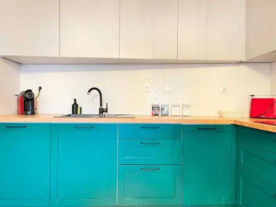 a kitchen with blue cabinets and a sink at Apartment with Terrace and Two Bedrooms, Cracow Vistula Boulevards in Kraków
