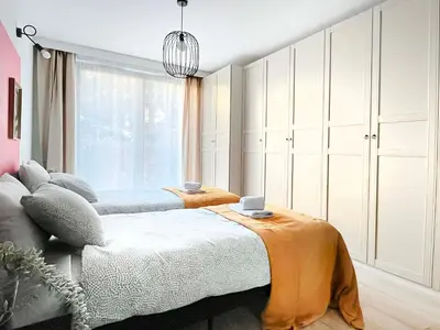 a bedroom with two beds and a large window at Apartment with Terrace and Two Bedrooms, Cracow Vistula Boulevards in Kraków