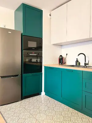 a kitchen with blue cabinets and a stainless steel refrigerator at Apartment with Terrace and Two Bedrooms, Cracow Vistula Boulevards in Kraków