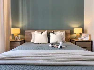 a bedroom with a large bed with two lamps at Nowoczesny Apartament Pychowicka 3B in Kraków
