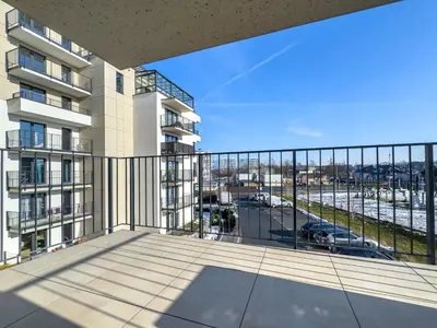an apartment balcony with a view of a parking lot at Nowoczesny Apartament Pychowicka 3B in Kraków
