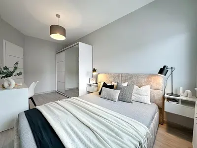 a bedroom with a large bed in a room at Krakowski zakątek- Apartament premium z garażem in Kraków