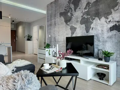 a living room with a large tv and a map wall at Krakowski zakątek- Apartament premium z garażem in Kraków
