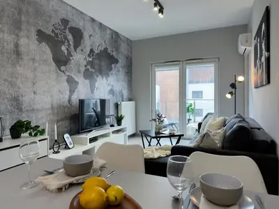 a living room with a table and a couch at Krakowski zakątek- Apartament premium z garażem in Kraków