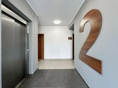 a hallway with a number on the wall at Krakowski zakątek- Apartament premium z garażem in Kraków