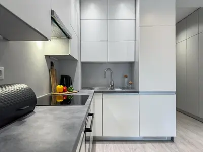 a kitchen with white cabinets and a sink at Krakowski zakątek- Apartament premium z garażem in Kraków