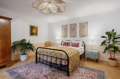 a bedroom with a bed and a rug at Mikołajska Apartment 2 in Kraków