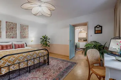 a bedroom with a bed and a table and a dining room at Mikołajska Apartment 2 in Kraków