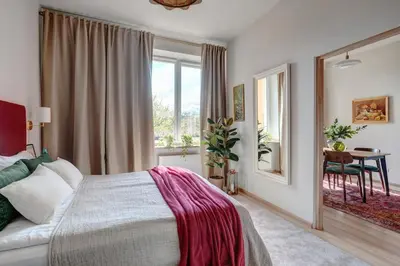 a bedroom with a bed and a window and a table at Basztowa 5a in Kraków