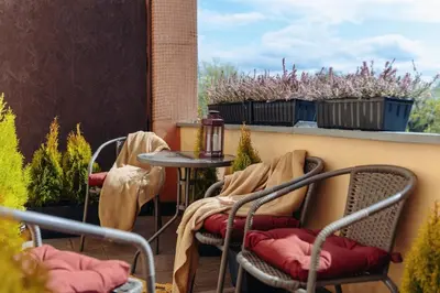 a patio with chairs and a table on a balcony at Basztowa 5a in Kraków