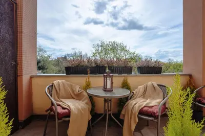 a patio with two chairs and a table on a balcony at Basztowa 5a in Kraków