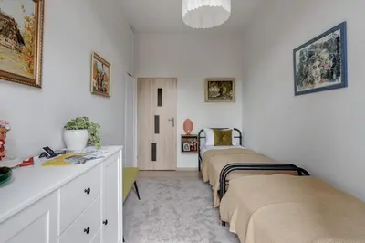 a bedroom with two beds and a dresser in it at Basztowa 5a in Kraków