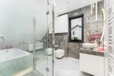 a bathroom with a shower and a tub and a sink at ZinHouse Wojakowa in Wojakowa