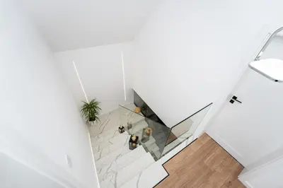 an overhead view of a room with white walls and wood floors at ZinHouse Wojakowa in Wojakowa