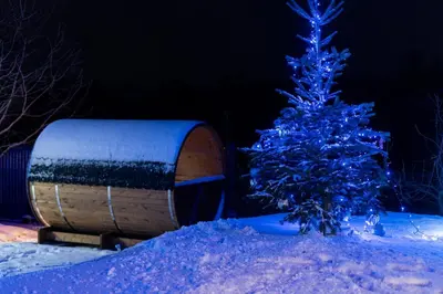 a blue christmas tree and a barrel in the snow at ZinHouse Wojakowa in Wojakowa