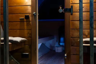 an open door of a wooden cabinet with towels at ZinHouse Wojakowa in Wojakowa