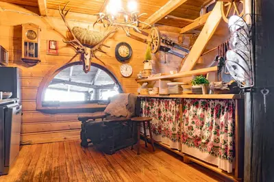 a room with a table in a wooden cabin at Chata Gołębiówka in Rzyki