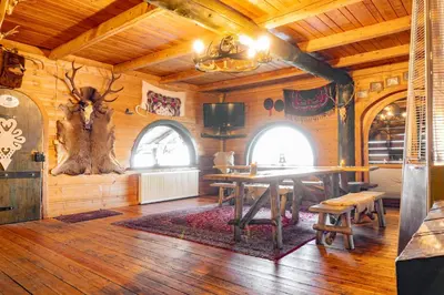 a dining room with a table in a cabin at Chata Gołębiówka in Rzyki