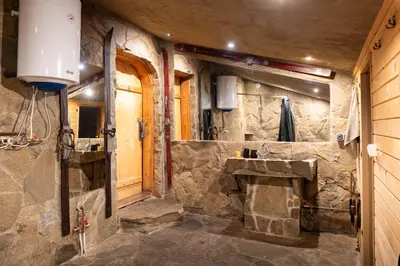a stone bathroom with a stone sink in a room at Chata Gołębiówka in Rzyki