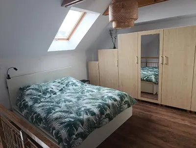a bedroom with a bed with a green blanket at Bukszpanowa Alejka domek całoroczny, okolica Ojcowski Park Narodowy in Milonki