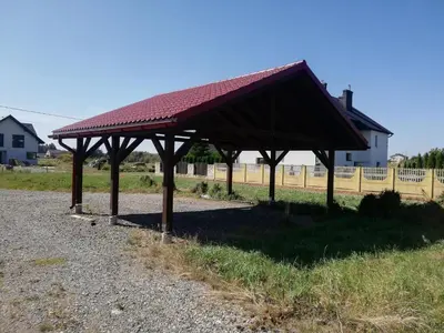 a pavilion with a red roof on a field at Bukszpanowa Alejka domek całoroczny, okolica Ojcowski Park Narodowy in Milonki